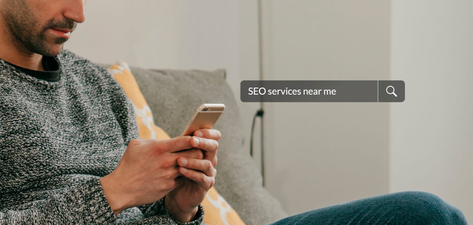 a man searching for seo services near me on his iphone