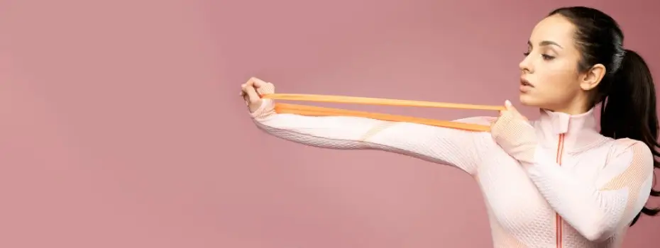 young woman stretches a fitness band